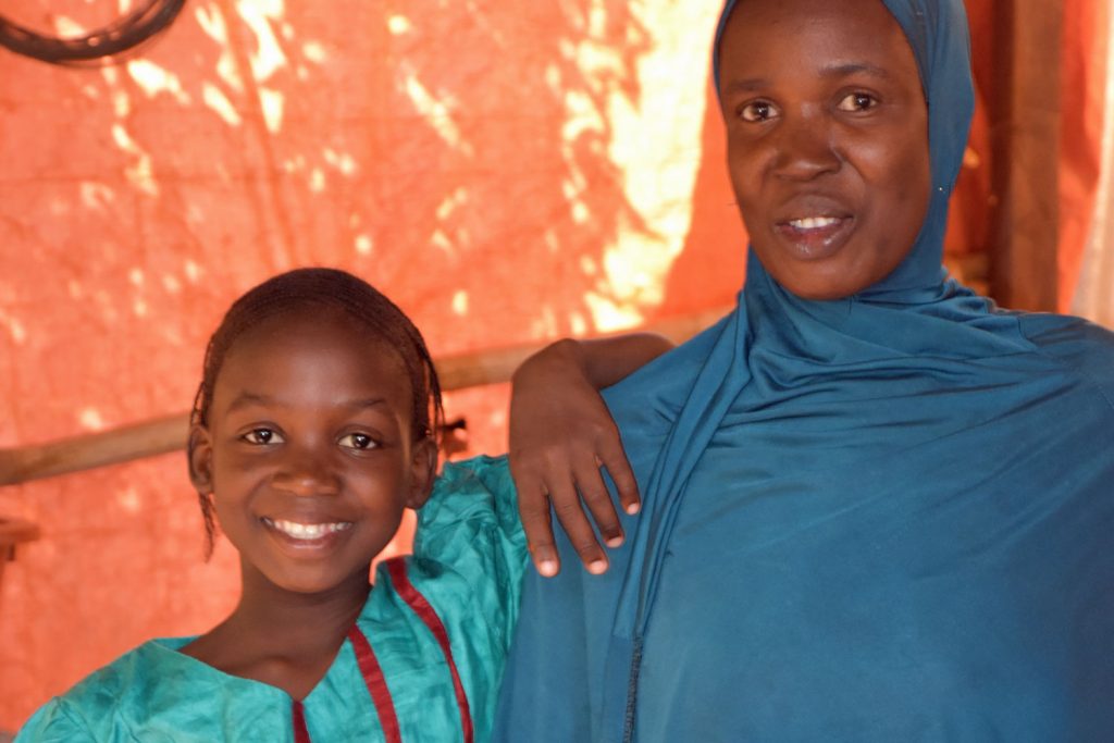 Amitou leans on her mother, Fatoumata