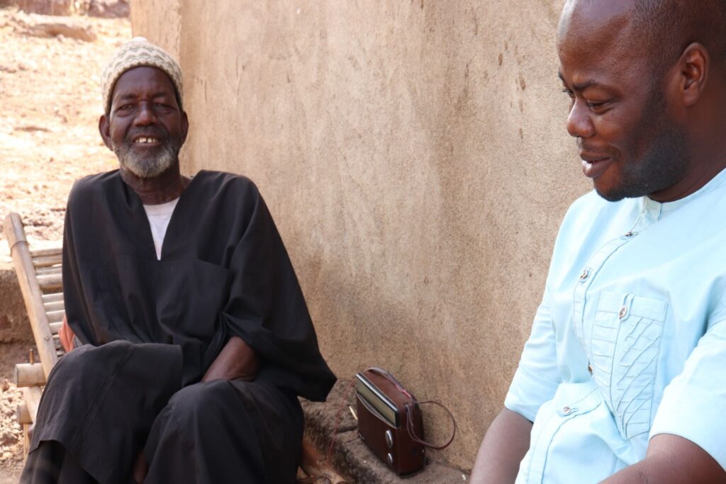 The chef du village speaks with Mali Health Director, Dramane Diarra.